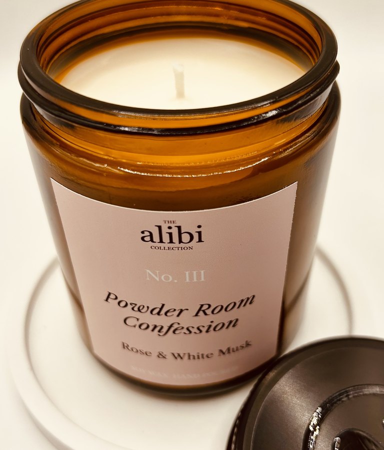 Powder Room Confession candle, lid off showing the wax and wick